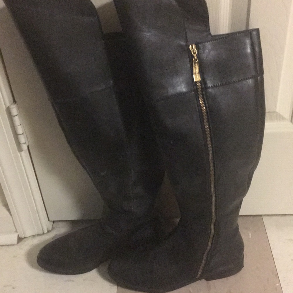 A pair of women’s black knee high boots.
